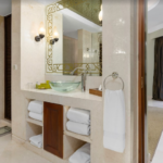 Bathroom with marble vanity and towels.