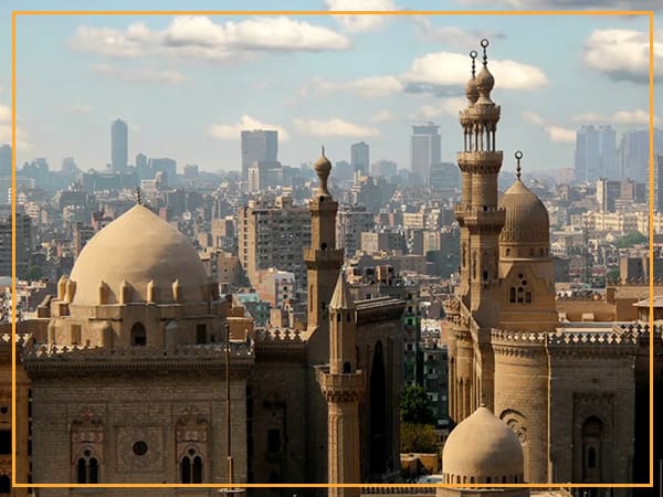 Mosque in Cairo with city skyline.