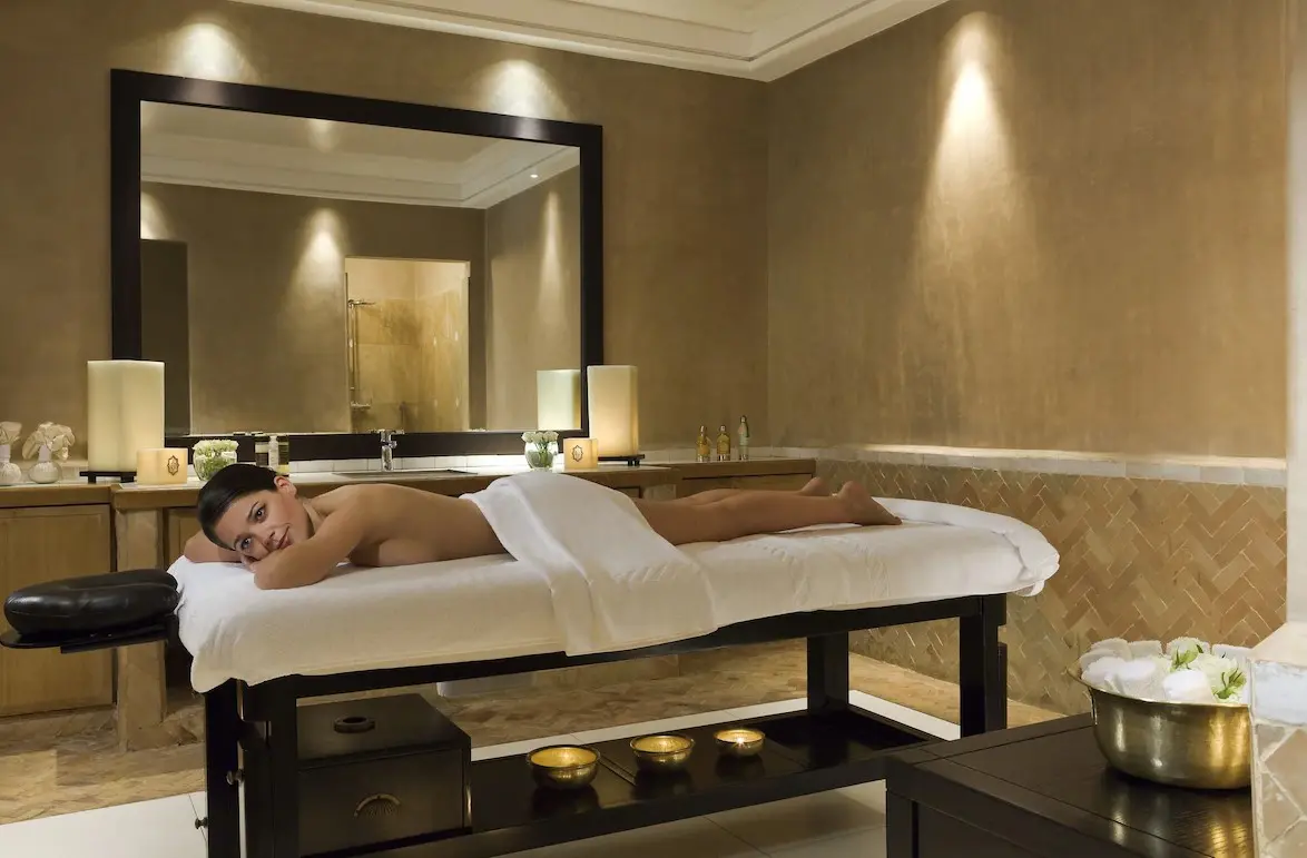 Woman relaxing on massage table in spa.