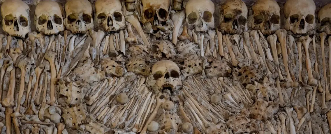 Wall of skulls and bones in a chapel.