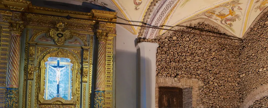 Ornate church interior with skull wall.