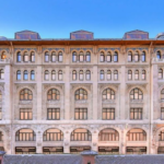 Large building with arched windows and ornate facade.