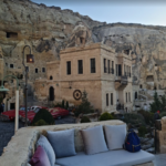 Stone building with a couch and view.