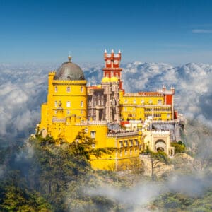 Yellow castle in clouds, Pena Palace, Portugal.