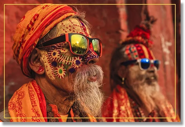 Man with colorful face paint wearing sunglasses.