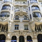 Ornate building facade with Prada storefront.