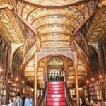 Ornate library interior with spiral staircase.