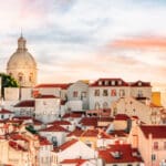 Portugal, Lisbon old town skyline at the Alfama district. Dramatic sky at sunset - City travel concept.