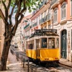 Yellow tram on a charming city street.