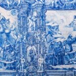 Blue and white tiled mural depicting biblical scenes.