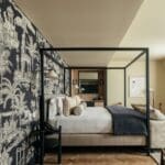 Elegant bedroom with decorative wallpaper design.