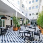 Outdoor dining area with patterned floor tiles.