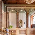 Elegant lobby with arches and chandelier.