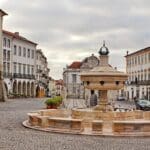 Quiet plaza with a central fountain.