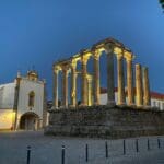 Ancient ruins illuminated at night.