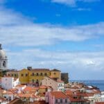 Lisbon skyline with coastal view and rooftops.