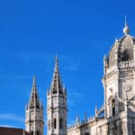 Lisbon; Portugal: Jeronimos monastery - UNESCO world heritage site - tower and spires, built in Portugese late Gothic, known as Manueline style - sky with copy space - Mosteiro Dos Jeronimos, Belem