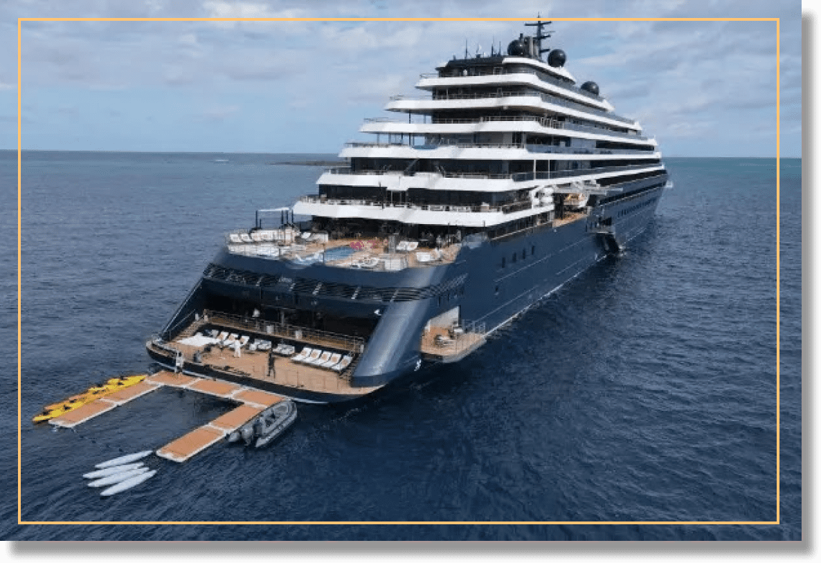 Luxury yacht anchored in calm blue waters.