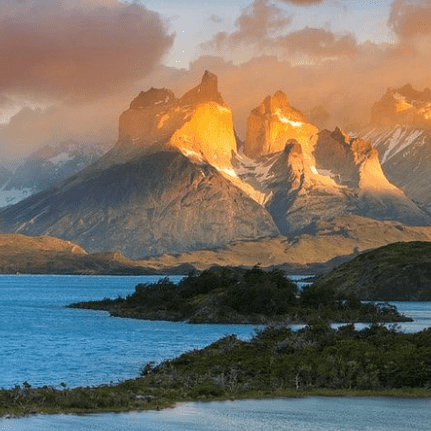 Mountain range reflected in lake at sunset.